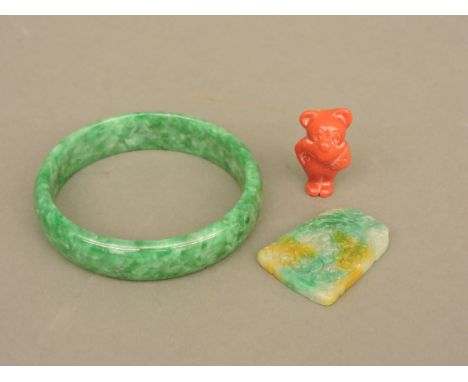 A Chinese green jade bangle, a pendant, and a coral carving of a mouse?