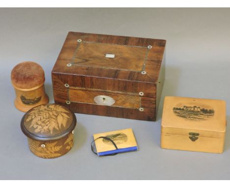 A Mauchline ware pin cushion, 8cm high, a similar small work box and needle wallet, a rosewood work box with a fitted interna