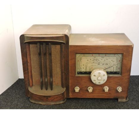 An Art Deco walnut case cabinet radio, by 'RAP', with white bakelite dials