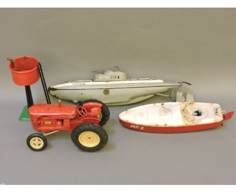 A 'Jep' tin toy submarine, a speedboat, a Massey Harris tractor, and a Hornby tin railway water tank