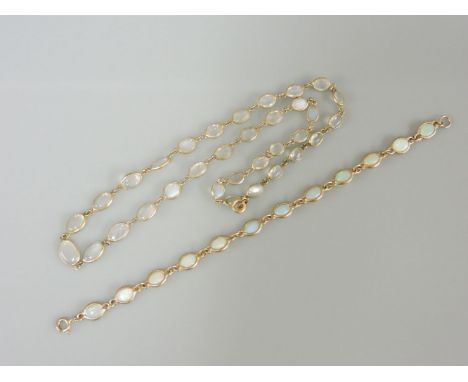 A silver gilt moonstone necklace, with spectacle settings, and a 9ct gold opal bracelet with spectacle settings