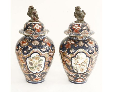 A decorative pair of Paris 'Arita Imari' vases and covers, circa 1880, each baluster body enamelled and gilt with panels of f