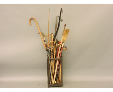 A stick stand, with walking sticks, shepherds' crooks, flag, etc