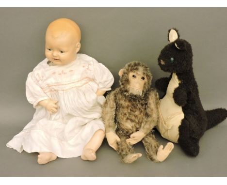 A Steiff mohair monkey, with musical workings, a wool kangaroo with glass eye, and a bisque head doll stamped ElH Co Inc