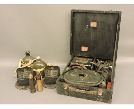 A pair of WWII car headlamps filters, two brass shells, water bottles, kukri, motor cycle helmet and goggles, etc