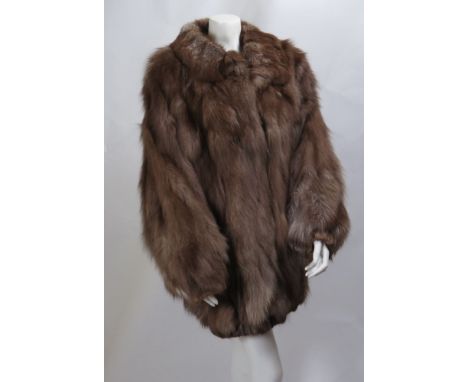 A dyed light brown fox fur coat, with short collar and gathered cuff sleeves