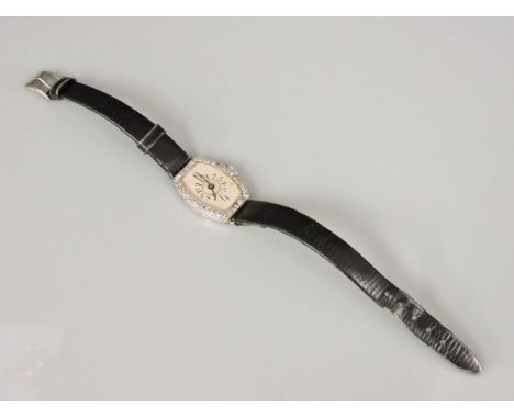 A ladies Art Deco tonneau shaped mechanical strap watch, with a diamond set bezel, case marked platinum