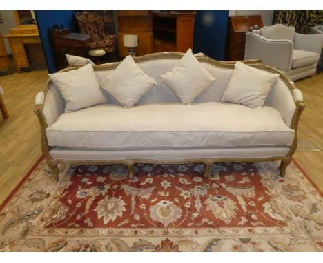 A modern French style show frame Sofa, raised shape back, upholstered elbow pads, oatmeal upholstery, seats three, with singl