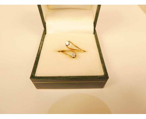 18ct diamond crossover ring, with two claw set half point stones, size K, 4.1g