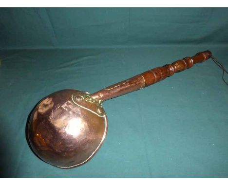 A 19th century copper Ladle, 21cm diameter with 58cm turned wooden handle 