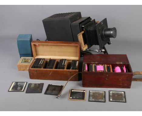 A Newton &amp; Co magic lantern, converted to electric,  along with spare bulb and three boxes of slides including The Baker 