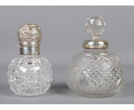 A silver topped globular hobnail cut scent bottle, together with a similar silver collared example. Silver topped example ass