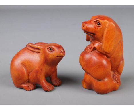A pair of Japanese carved netsuke figures in the form of a rabbit and a pig.Pig height 5.5cm approxRabbit height 3.5cm approx