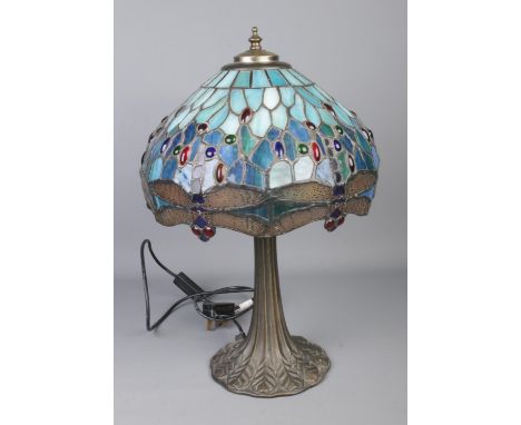 A Tiffany style lamp and shade featuring blue dragonfly design.  