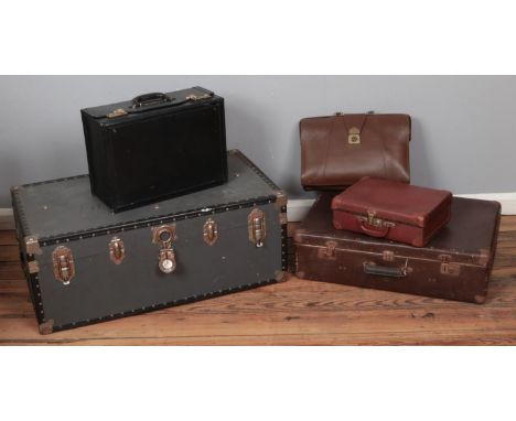 A quantity of vintage luggage. Includes travel trunk, combination code briefcase, etc.  