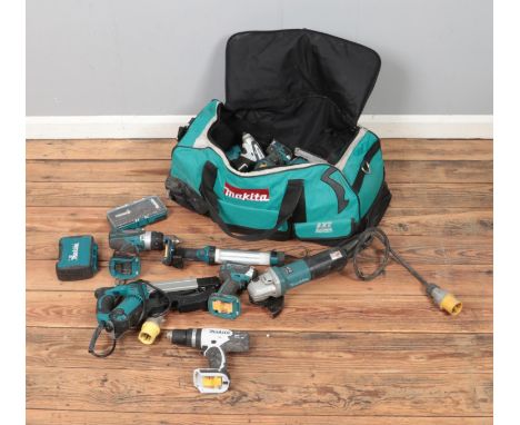 A large Makita carry bag with a quantity of power tools including nail gun, drills, jigsaw, angle grinder, work lamp and a se