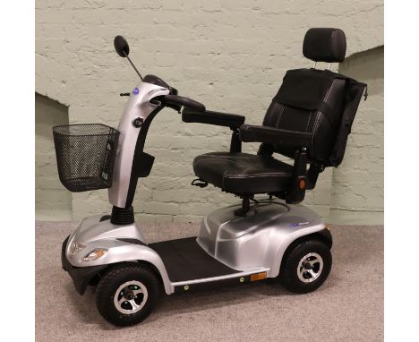 An Invacare Orion mobility scooter. With two keys, owner's manual and Opticharge 8 Battery Pack with charging cable.  In work