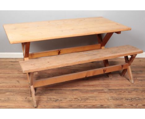 A pine kitchen table with X-Frame base, together with a pine bench of similar design. Dimensions of table - Height: 72cm, Wid