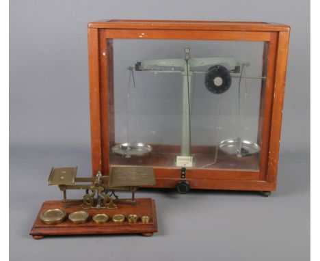 A cased set of chemical scales along with vintage brass postal scales with weights.  