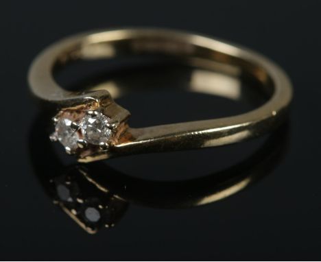 A 9ct gold moi et toi ring set with two diamonds.Size MÂ½Weight 2.1g1/32ct diamonds  