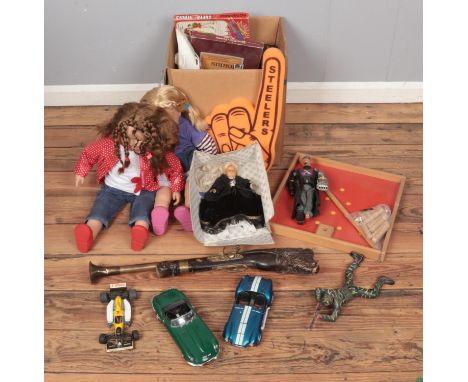 A box of toys and games. Includes dolls, K'Nex, Dr X Action Man figure, diecast vehicles, etc.  