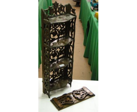 A Black Forest narrow small carved shelf with foliate design and a carved extending table top book rack.