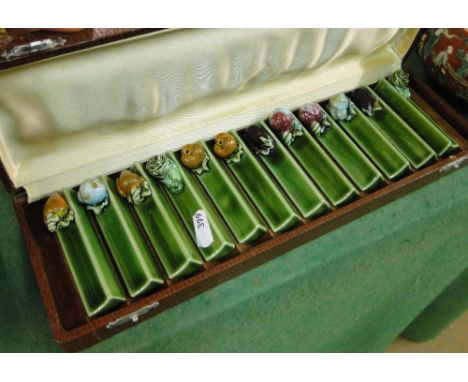 A cased set of ceramic knife rests.
