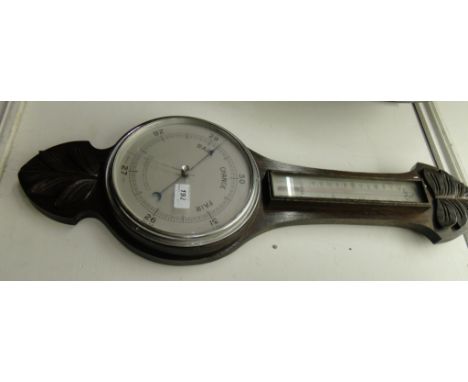 A Barometer with thermometer in carved wood case