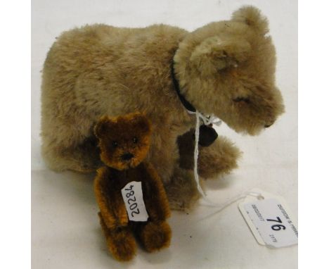 A Vintage toy bear with bell and a miniature jointed bear possibly Schuco.