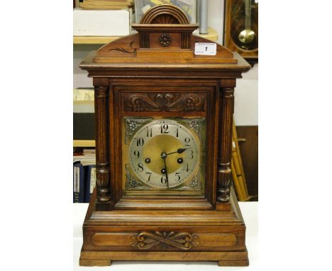 A Victorian carved wood cased bracket clock.