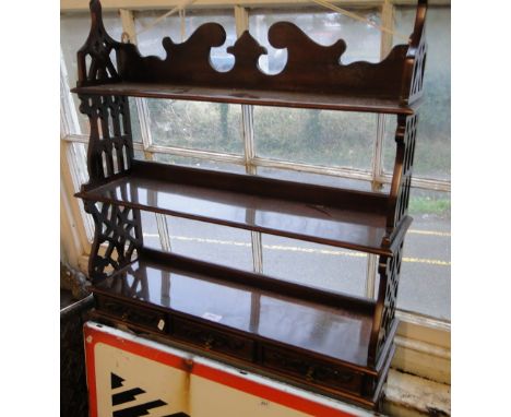 A reproduction mahogany 3-tier hanging shelf with 3 drawers.