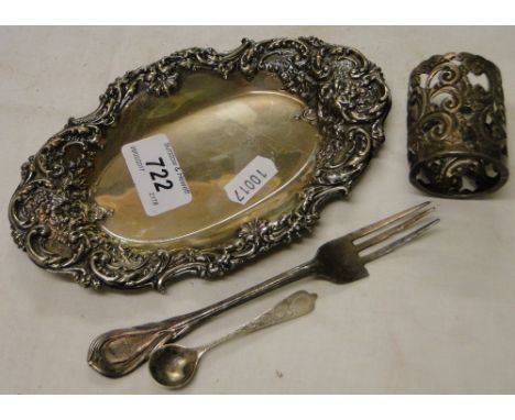 An embossed silver oval card tray, a silver holder, fork and spoon