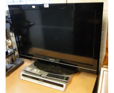 A Toshiba 32" flatscreen coloured TV with remote and a Panasonic DVD recorder.