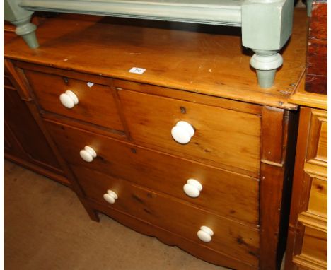 An Antique pine 4-drawer chest on bracket feet.