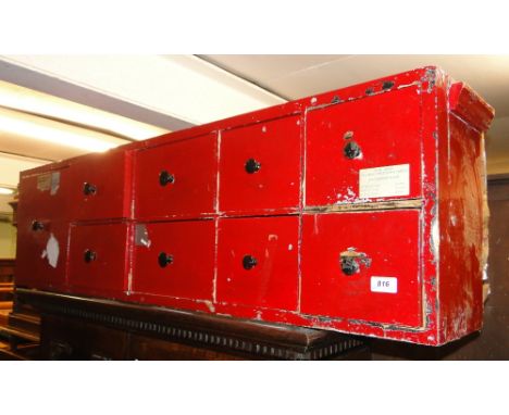 A Vintage red painted pine 9-drawer haberdashery chest.