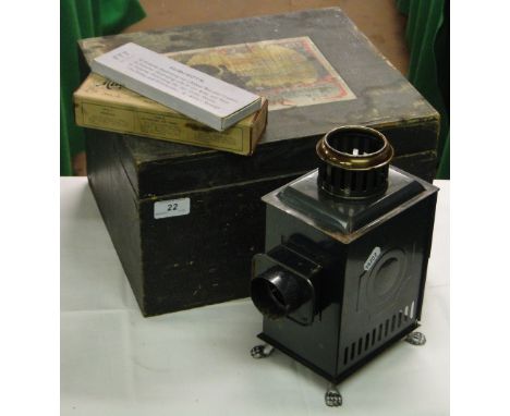 A Bing magic lantern with various slides in case.