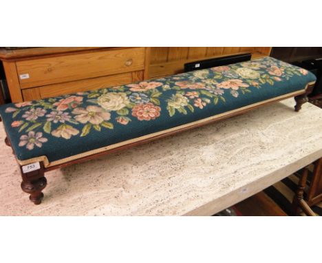An Edwardian mahogany and tapestry upholstered fender stool.