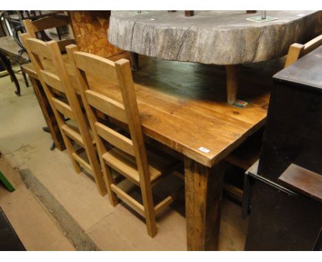 A large pine plank top dining table on chunky square legs, together with a set of 8 beech ladder back dining chairs, table le