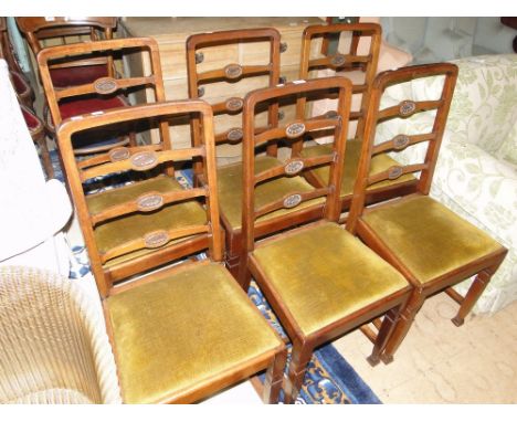 A set of 6 mahogany carved ladder back dining chairs by J & S Shoolbred & Co., labels on the underside of the seats. 
