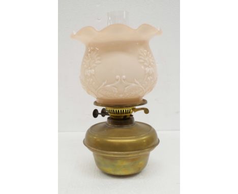 An oil lamp with pink glass shade **PLEASE NOTE THIS LOT IS NOT ELIGIBLE FOR IN-HOUSE POSTING AND PACKING** 