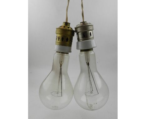 A pair of ceiling pendants, in the shaped of light bulbs.