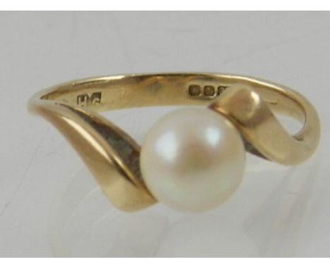 A 9 carat yellow gold and pearl set crossover style ring.