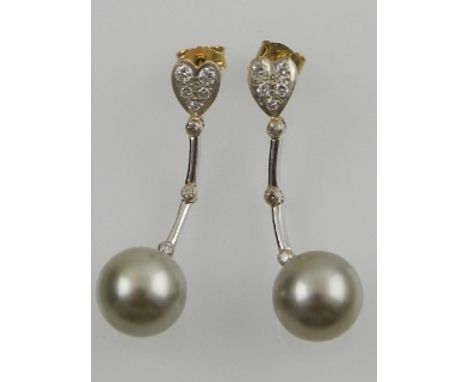 A pair of 18 carat white gold, diamond, and South Sea grey pearl drop earrings. 