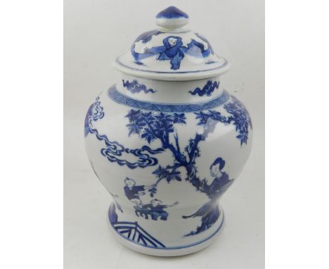 A Kangxi style blue and white porcelain jar and cover, having continuous decoration of playing children, bears double blue ci