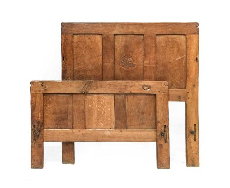 Robert Mouseman Thompson (1876-1955): An English Oak 3'2" Single Bedstead, 1930s, the headboard with three panels, central pa