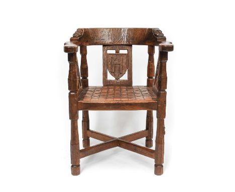 Robert Mouseman Thompson (1876-1955): An English Oak Monk's Chair, circa 1930s, with curved back and shaped arms, each side c