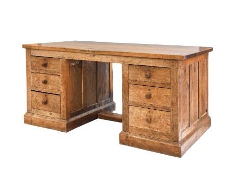 Robert Mouseman Thompson (1876-1955): An English Oak Panelled Partners' Desk, circa 1932, dowelled two plank top with carved 