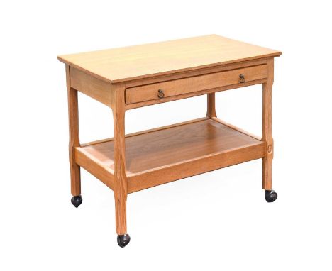 Acorn Industries: G.J.Grainger and Son (Brandsby): An Oak Tea Trolley, smooth top, above a drawer and undertier shelf, on fou