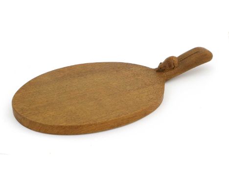 Workshop of Robert Mouseman Thompson (Kilburn): An English Oak Cheese Board, post 1960, of standard form, with carved mouse t