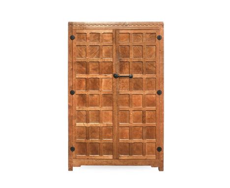 Robert Mouseman Thompson (1876-1955): An English Oak Panelled Tall Double Wardrobe, 1930's, with burr oak panels, half penny 